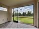 Screened lanai shows brick flooring and view of fenced backyard at 12705 Pinnacle Ln, Venice, FL 34293