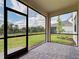 Screened lanai shows brick flooring and view of fenced backyard at 12705 Pinnacle Ln, Venice, FL 34293