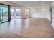 Spacious living room with hardwood flooring, large sliding glass doors and neutral walls, perfect for entertaining at 12705 Pinnacle Ln, Venice, FL 34293