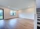 Bright living room with hardwood floors, large windows, and a sliding glass door leading to the outside at 12705 Pinnacle Ln, Venice, FL 34293