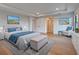 A modern main bedroom with neutral paint, wood flooring, and beach-themed decor at 12705 Pinnacle Ln, Venice, FL 34293