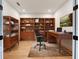 Well-decorated office with built-in shelving, a desk, and a comfortable chair, perfect for working from home at 12705 Pinnacle Ln, Venice, FL 34293