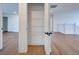 A walk-in pantry features bright, white shelving and sleek, black hardware at 12705 Pinnacle Ln, Venice, FL 34293
