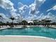 Beautiful view of the community pool and clubhouse surrounded by lush greenery at 12705 Pinnacle Ln, Venice, FL 34293
