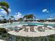 Beautiful community pool surrounded by palm trees and comfortable lounge chairs for residents at 12705 Pinnacle Ln, Venice, FL 34293
