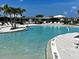 Resort-style pool with lounge chairs and lush landscaping offers a relaxing oasis at 12705 Pinnacle Ln, Venice, FL 34293