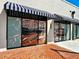 Charming storefront with awnings and decorative window displays of dining interiors at 12705 Pinnacle Ln, Venice, FL 34293