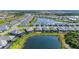 Aerial view shows community, water features, and lush landscaping at 12816 Morning Mist Pl, Venice, FL 34293