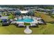 Aerial view of the community pool area, showcasing its size, amenities, and landscaping within the neighborhood at 12816 Morning Mist Pl, Venice, FL 34293