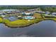 An expansive aerial view of the Solstice Wellen Park community showcasing pool, tennis courts, and scenic waterfront at 12816 Morning Mist Pl, Venice, FL 34293