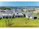 Aerial view of new homes with manicured lawns and lake at 12816 Morning Mist Pl, Venice, FL 34293