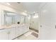 Luxurious bathroom featuring dual sinks, a large mirror, and a walk-in shower at 12816 Morning Mist Pl, Venice, FL 34293