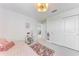 Comfortable bedroom with neutral tones, a decorative rug, and a closet with sliding doors at 12816 Morning Mist Pl, Venice, FL 34293