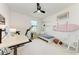 Bright bedroom with desk, daybed, ceiling fan, and charming decor at 12816 Morning Mist Pl, Venice, FL 34293
