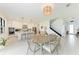 Cozy dining area with a view of the modern kitchen, featuring a stylish table and contemporary decor at 12816 Morning Mist Pl, Venice, FL 34293