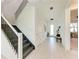 Spacious entryway featuring a staircase and a welcoming bench at 12816 Morning Mist Pl, Venice, FL 34293