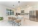 Gourmet kitchen boasts a spacious island with seating and stainless steel appliances at 12816 Morning Mist Pl, Venice, FL 34293