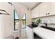 Well-lit laundry room with modern washer and dryer and ample storage at 12816 Morning Mist Pl, Venice, FL 34293