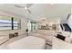Open-concept living room with a view of the lake, featuring a comfortable sofa and staircase at 12816 Morning Mist Pl, Venice, FL 34293
