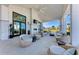Inviting outdoor patio with comfortable seating, fireplace, and views of the lush community landscape at 12816 Morning Mist Pl, Venice, FL 34293