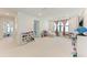 Bright playroom with storage bins, a comfortable daybed, and neutral tones at 12816 Morning Mist Pl, Venice, FL 34293