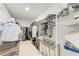 Organized walk-in closet with white shelving, hanging rods, and ample storage space for clothing and accessories at 12816 Morning Mist Pl, Venice, FL 34293