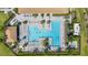 Aerial view of the stunning community pool featuring multiple pools, lounge chairs, and lush landscaping at 13486 Nobilio St, Venice, FL 34293