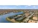 Community aerial view featuring tennis courts and a lake at 13486 Nobilio St, Venice, FL 34293