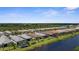 Scenic aerial of homes with waterway views, screened lanais, and lush greenery at 13486 Nobilio St, Venice, FL 34293