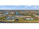 Panoramic aerial view of the community showcasing the lakes, tennis courts, clubhouse, and pool area at 13486 Nobilio St, Venice, FL 34293