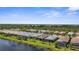 Beautiful aerial view of homes along the waterway with screened lanais and lush landscaping at 13486 Nobilio St, Venice, FL 34293