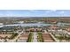Aerial view showcases a community with a pool, clubhouse, and beautiful lake views at 13486 Nobilio St, Venice, FL 34293