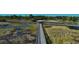 Scenic boardwalk stretches across a lush marshland, offering a tranquil escape into nature at 13486 Nobilio St, Venice, FL 34293