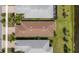 Overhead view of the brown roof, green grass, and adjacent bodies of water at 13486 Nobilio St, Venice, FL 34293
