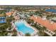 Aerial view of the resort pool and clubhouse surrounded by palm trees and residences at 13486 Nobilio St, Venice, FL 34293