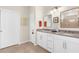 Bathroom featuring double sinks and a vanity with neutral colors and a framed mirror at 13486 Nobilio St, Venice, FL 34293