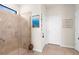 Bathroom featuring a tiled shower with glass door and neutral-colored walls at 13486 Nobilio St, Venice, FL 34293