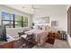 Bedroom with large window offering outside views and a ceiling fan overhead at 13486 Nobilio St, Venice, FL 34293