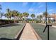Enjoy the beautiful bocce ball courts with lounge chairs and umbrellas surrounded by palm trees on a sunny day at 13486 Nobilio St, Venice, FL 34293