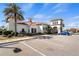 Beautiful IslandWalk clubhouse exterior with Mediterranean architecture, palm trees, and ample parking at 13486 Nobilio St, Venice, FL 34293