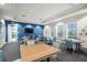 Inviting common room featuring tables, chairs, a mounted TV, and ample natural light at 13486 Nobilio St, Venice, FL 34293