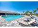 Spacious community pool area with lounge chairs and inviting blue water under a sunny sky at 13486 Nobilio St, Venice, FL 34293