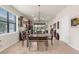 Eat-in dining area with view of gourmet kitchen, open floor plan and patio doors to the lanai at 13486 Nobilio St, Venice, FL 34293