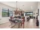 Eat-in dining area with view of gourmet kitchen, open floor plan and patio doors to the lanai at 13486 Nobilio St, Venice, FL 34293