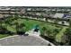 Aerial view of a fenced in dog park with shade feature at 13486 Nobilio St, Venice, FL 34293
