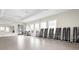Well-equipped exercise room with free weights, ample space, and natural light from large windows at 13486 Nobilio St, Venice, FL 34293