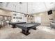 Entertaining game room with pool tables, ping pong, and comfortable seating, perfect for recreation and socializing at 13486 Nobilio St, Venice, FL 34293
