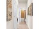 Hallway view featuring a bathroom at the end with beige tile and a shower with a curtain at 13486 Nobilio St, Venice, FL 34293