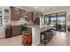 Modern kitchen with stainless steel appliances, tiled backsplash, and a breakfast bar with seating at 13486 Nobilio St, Venice, FL 34293