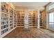 Spacious library with floor to ceiling bookshelves and a ladder for accessing high shelves at 13486 Nobilio St, Venice, FL 34293